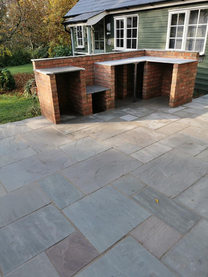 Patio installation in progress showing slab laying on prepared base